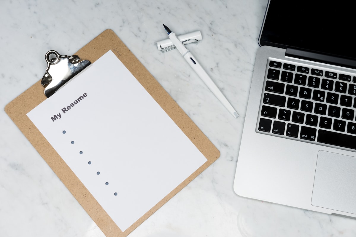 Professional drafting a short cover letter on a laptop