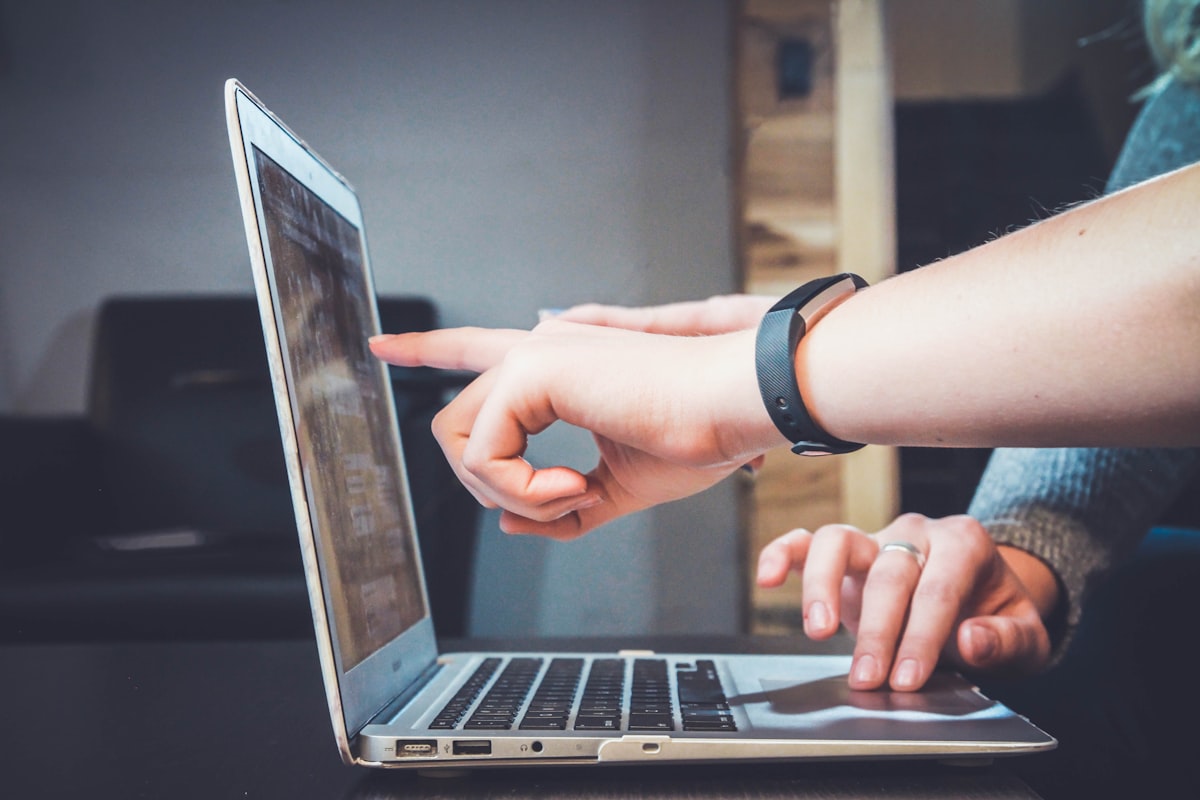 Writer editing AI resume bullets on a laptop